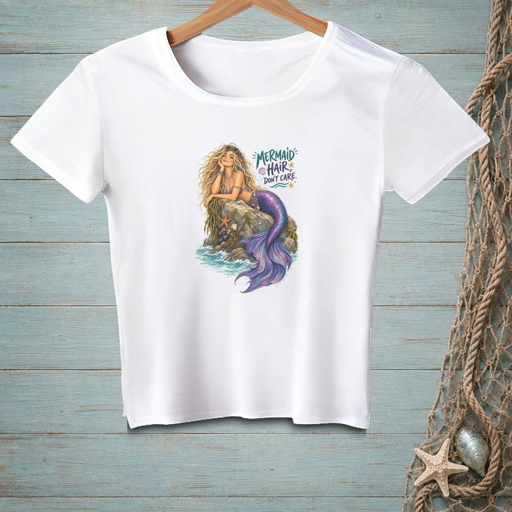 White t-shirt with a graphic of a mermaid on a rock and text "Mermaid Hair Don't Care."