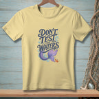 Yellow t-shirt with "Don't Test The Waters" and a mermaid tail and crab.