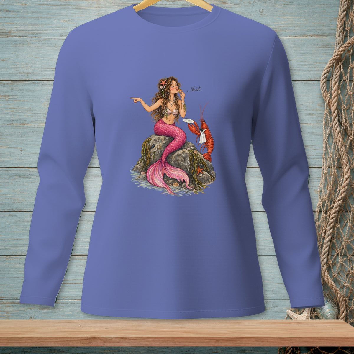 Illustration of a mermaid eating lobster with "Next." text on a purple long-sleeved shirt.