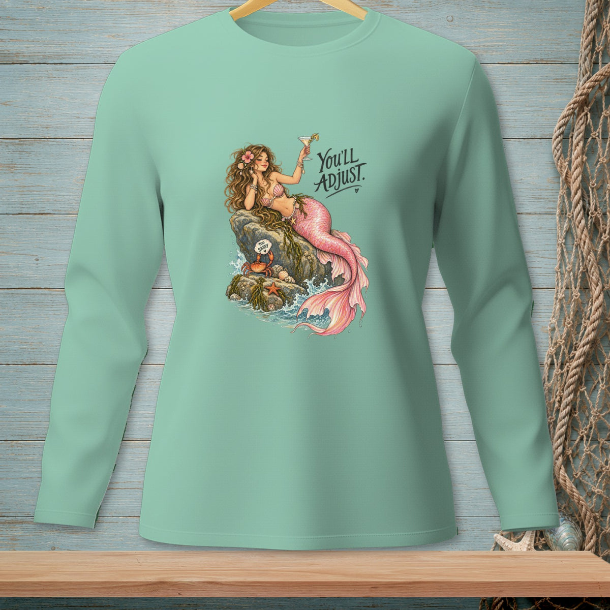 Green long-sleeve shirt with mermaid graphic and "You'll ADJUST." text.