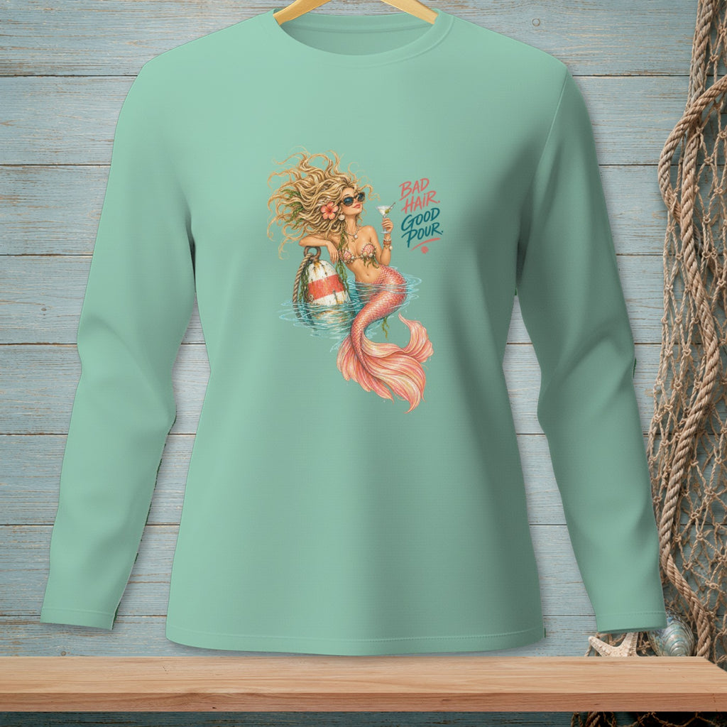 Mermaid with drink and text "BAD HAIR GOOD POUR" on mint green long sleeve shirt.