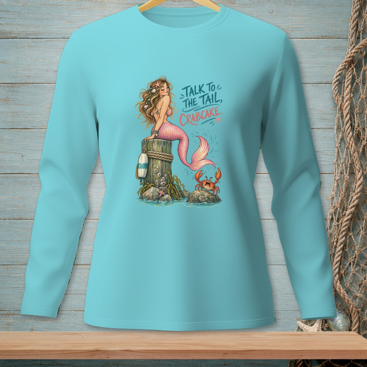 Mermaid on post with crab, text "Talk to the tail, crabcake."