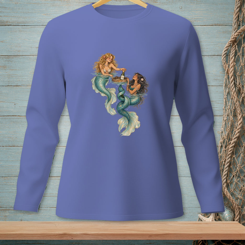 Two mermaids sharing drinks from a floating tray on a long-sleeved purple shirt.
