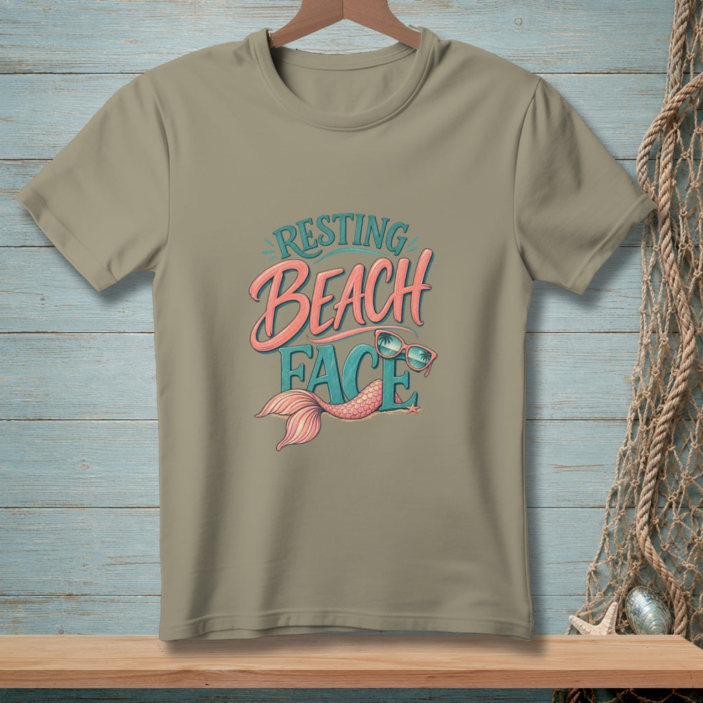 Tan t-shirt with "Resting Beach Face" text, mermaid tail, and sunglasses graphic.