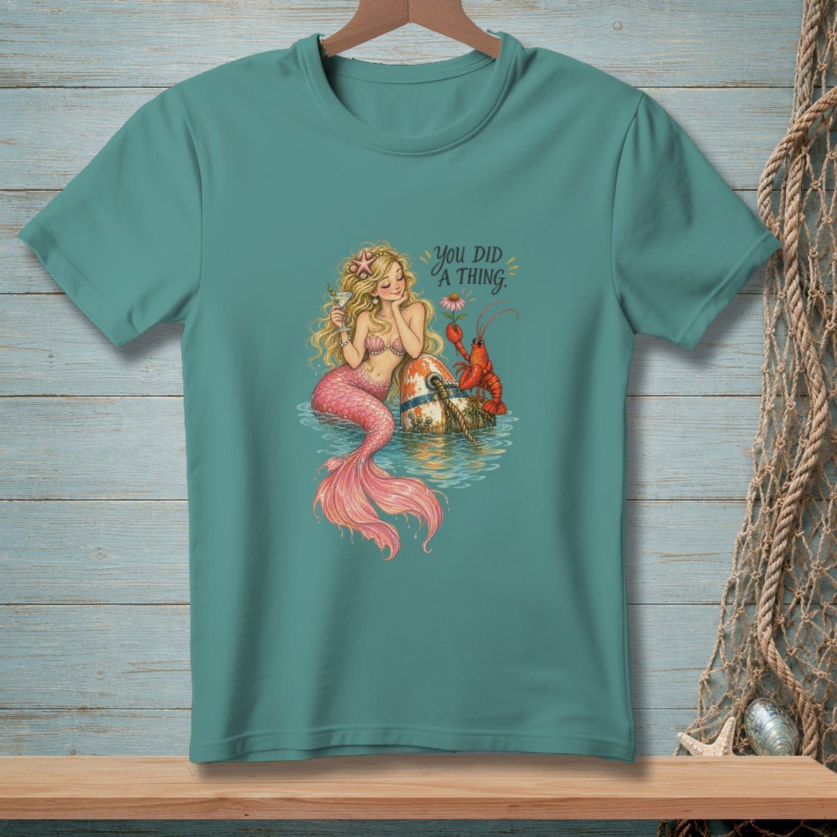 Mermaid with lobster on a buoy, text "You Did A Thing."