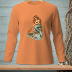 Mermaid holding pearl, with crab on rocks, on an orange long-sleeved shirt.