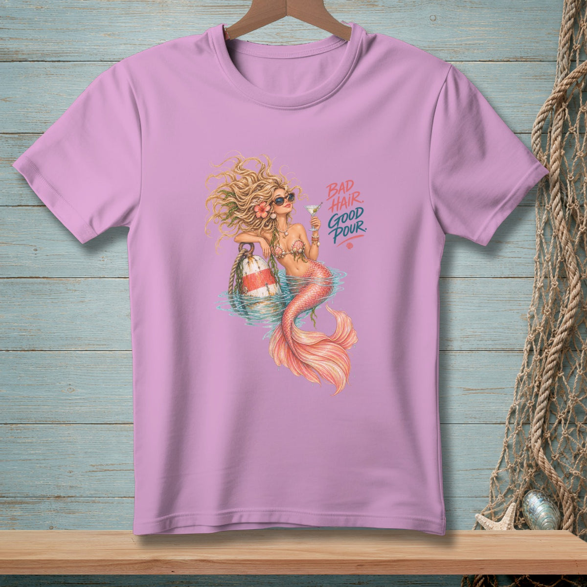 Pink t-shirt with mermaid graphic and text "BAD HAIR GOOD POUR."
