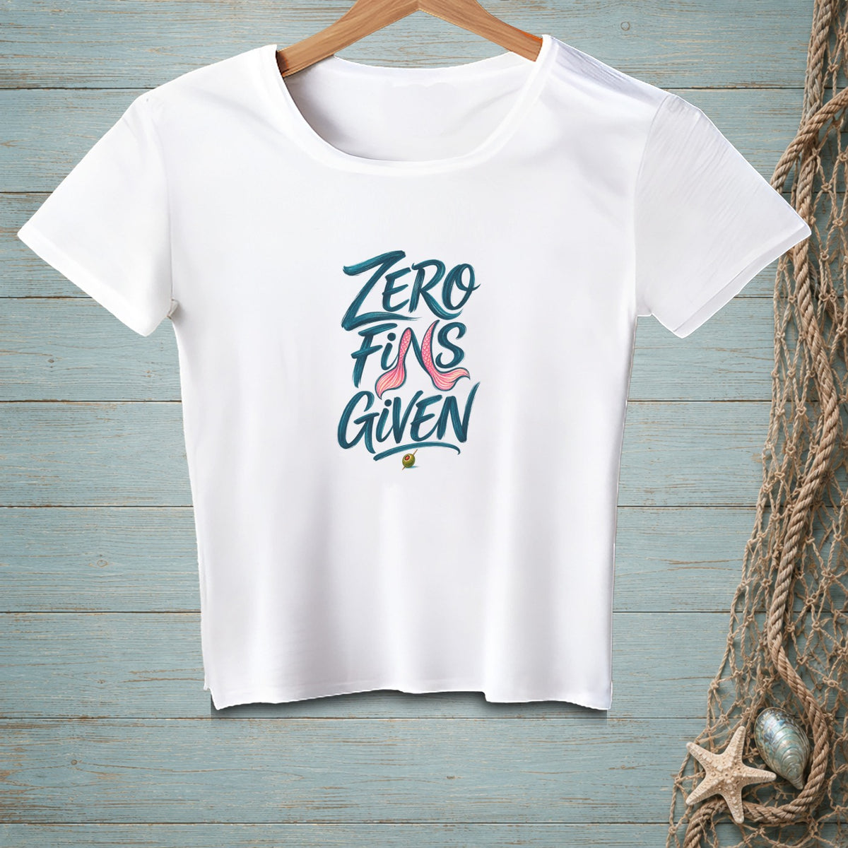 White t-shirt with "Zero Fins Given" text and a pink mermaid tail graphic.