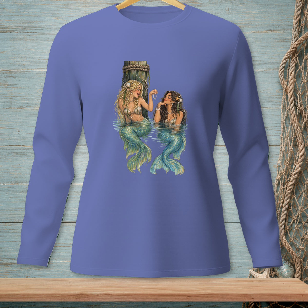 Two mermaids with green tails near a wooden dock and a pearl necklace.