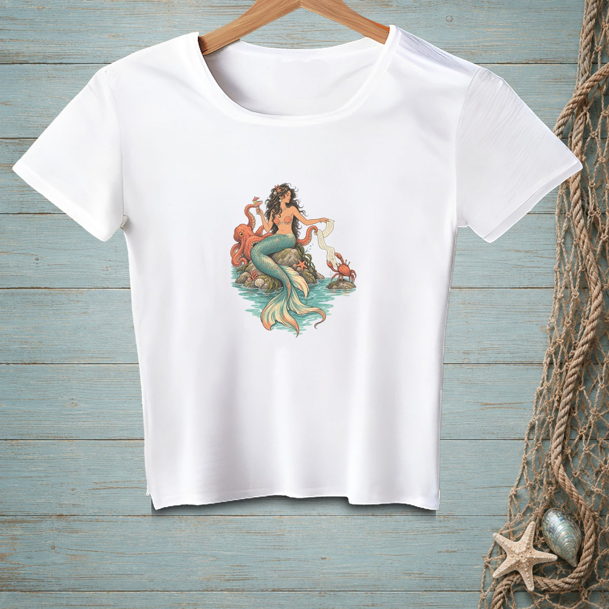 White t-shirt with a mermaid, octopus, crab, and seashells illustration.