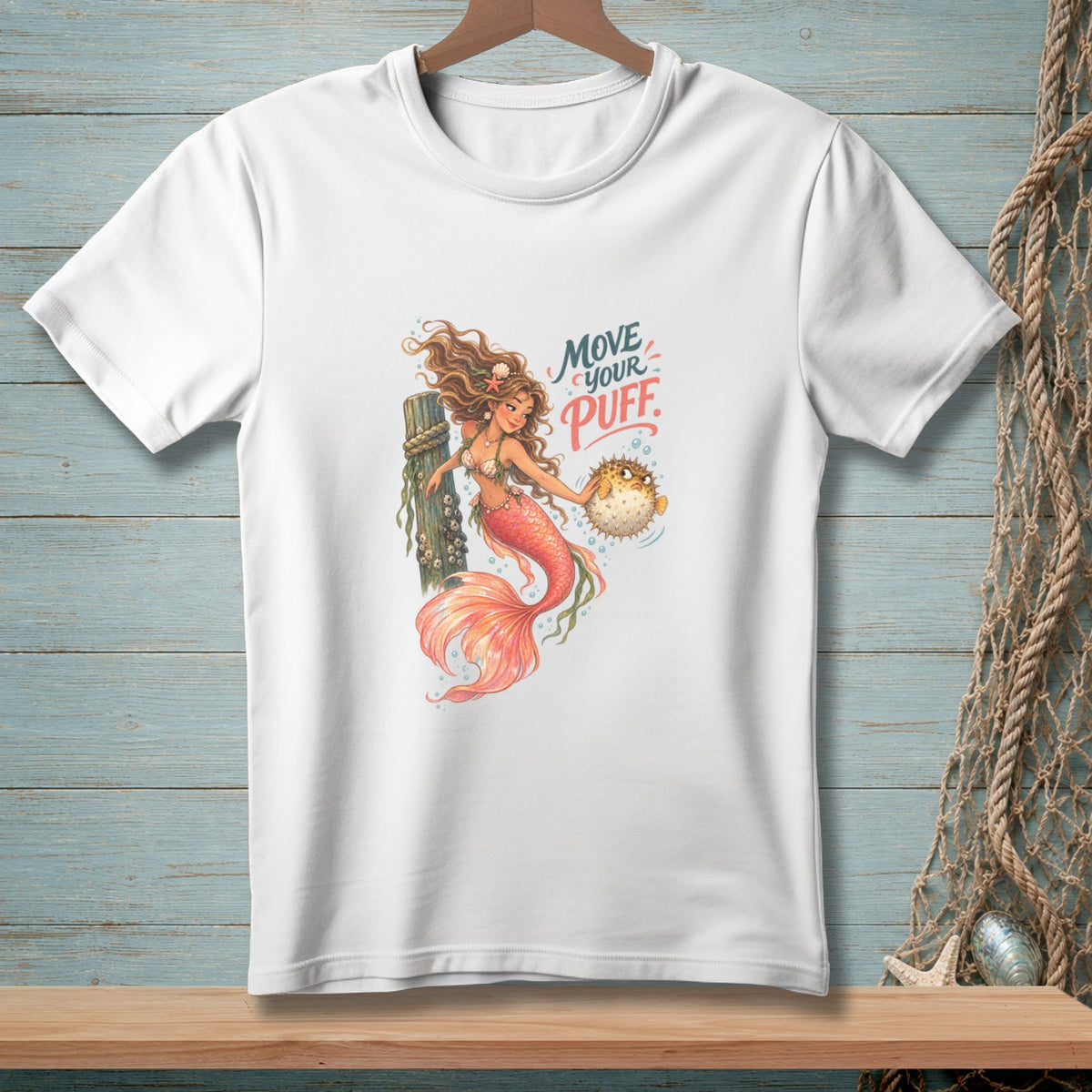 White t-shirt with mermaid holding pufferfish and text "Move Your Puff."