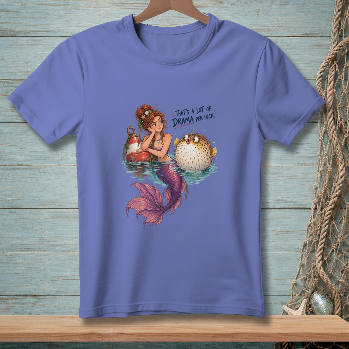Mermaid with a pufferfish on a shirt that reads "That's a lot of drama per inch."