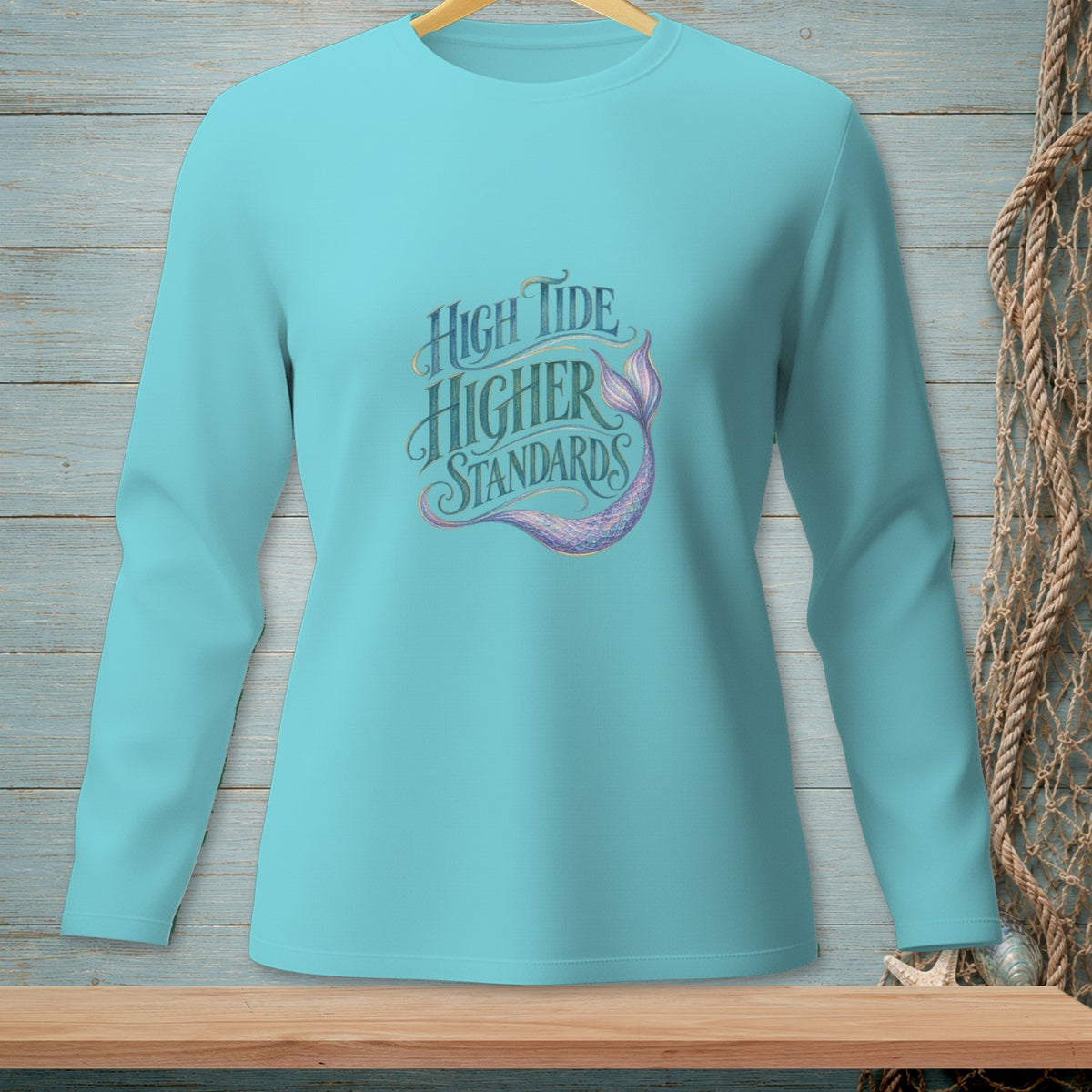Aqua long sleeve shirt with "High Tide Higher Standards" and mermaid tail graphic.