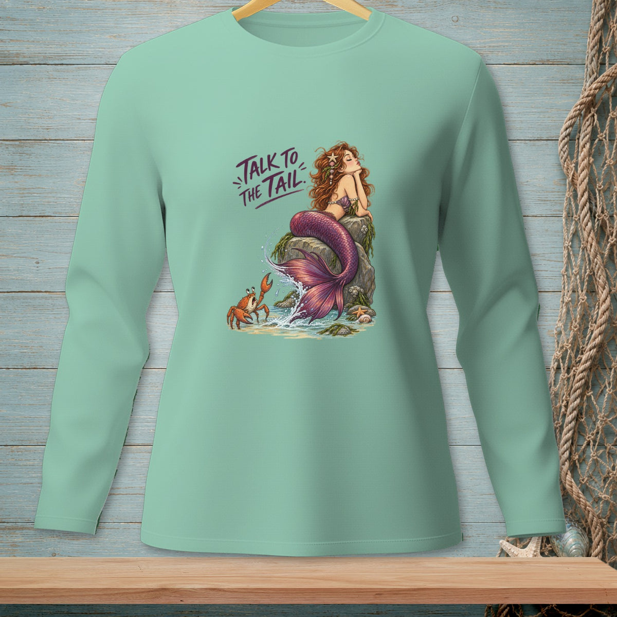 Mermaid with text "Talk to the Tail" sitting on a rock with a crab.