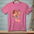 Pink t-shirt with a mermaid, pufferfish, and text that reads "Well, Somebody's Puffy."