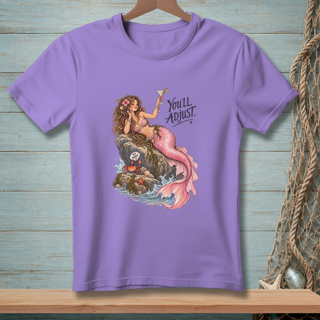 Purple t-shirt with a mermaid holding a cocktail and text that reads "You'll Adjust."