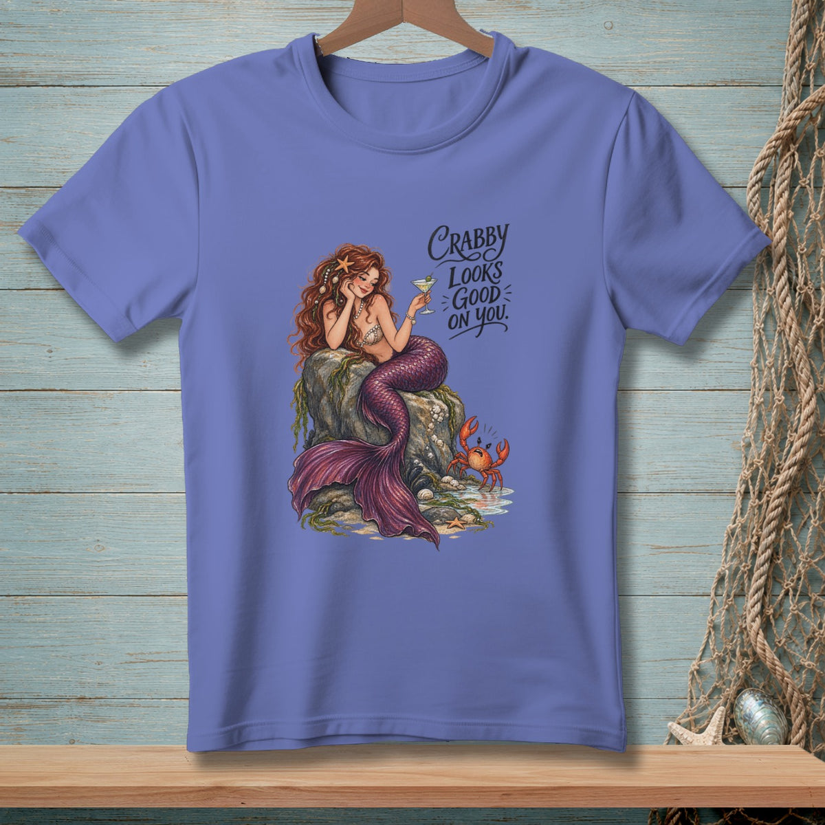 Mermaid on rock with crab and cocktail, text "Crabby Looks Good On You".