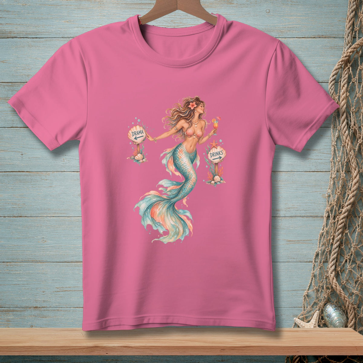 Pink t-shirt with a mermaid holding a drink, pointing to "Drama" and "Drinks" signs.