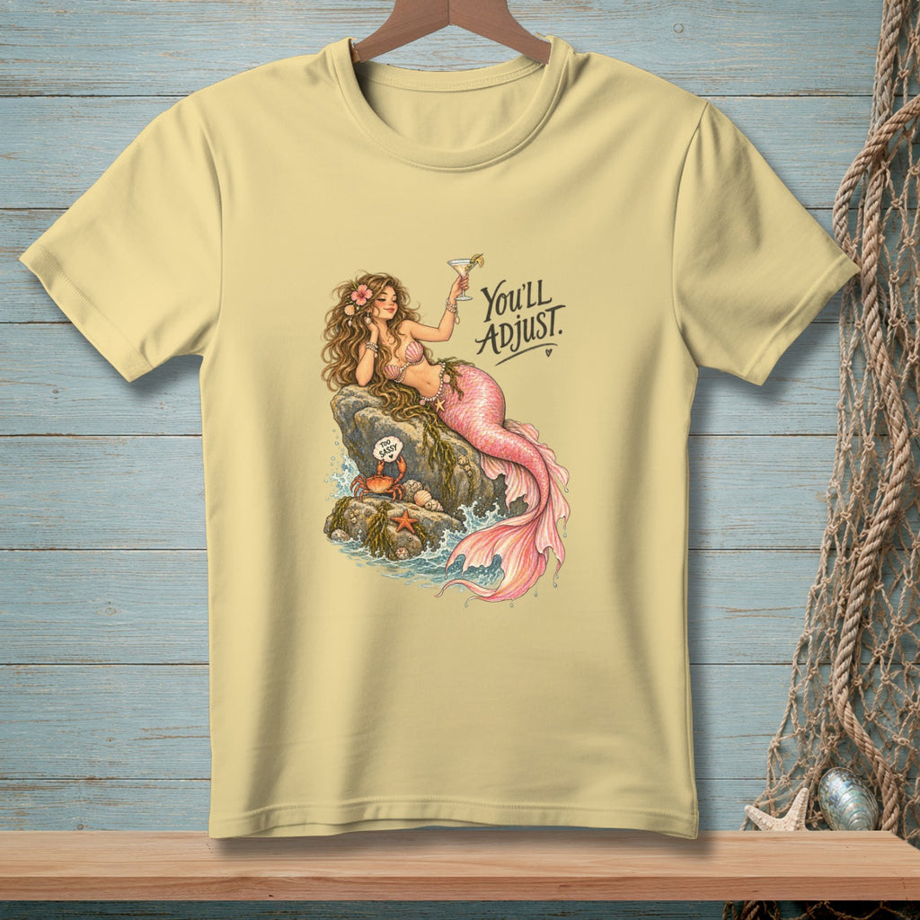 Yellow t-shirt with a mermaid drinking a martini and text that reads "You'll Adjust."