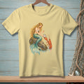 Light yellow t-shirt with a mermaid holding a pearl beside a lobster.