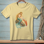 Light yellow t-shirt with a mermaid holding a pearl beside a lobster.