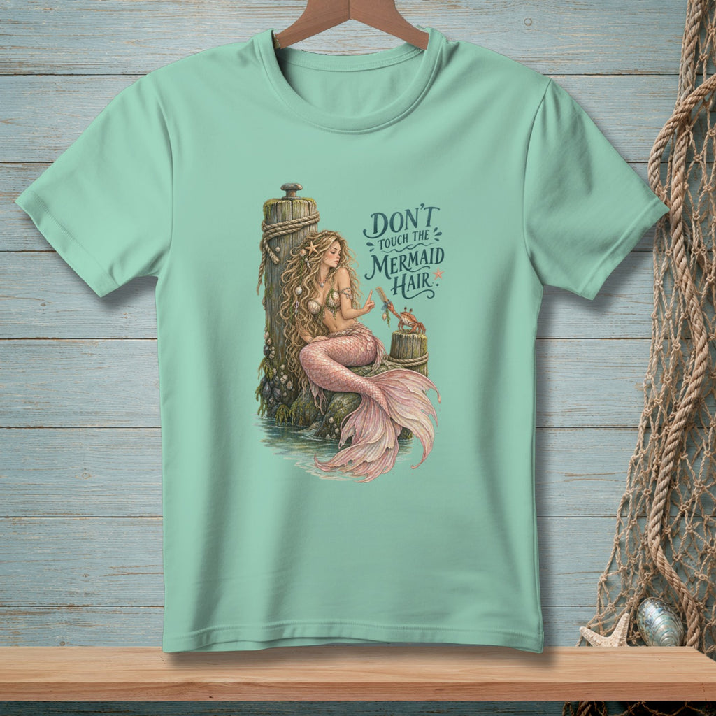 Mint t-shirt with a mermaid illustration and text "Don't touch the mermaid hair".
