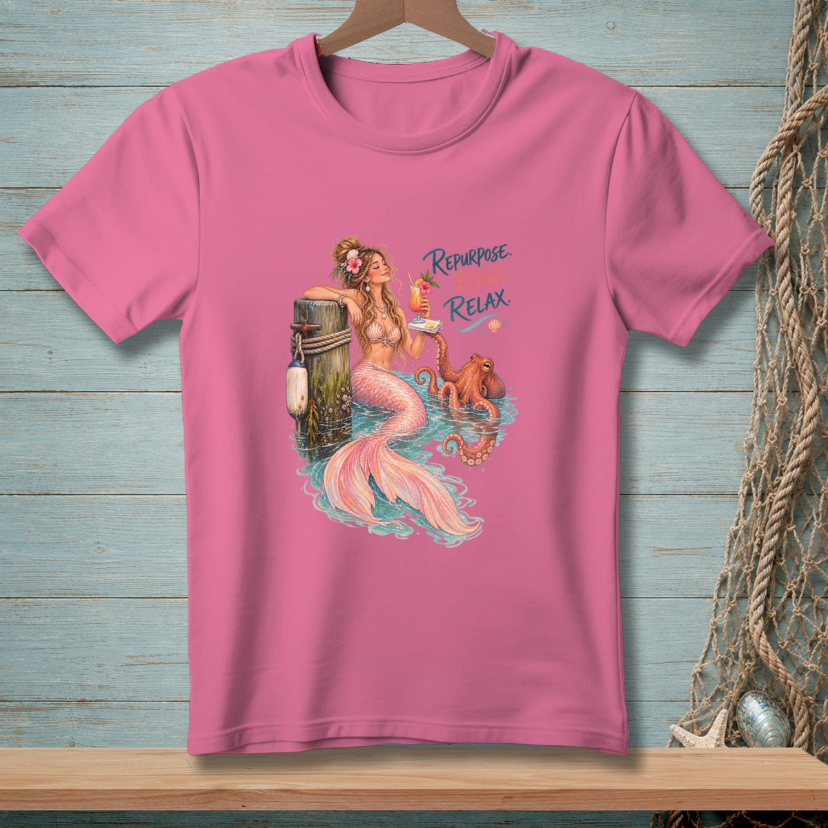 Pink t-shirt graphic of mermaid with octopus and text "Repurpose. Reuse. Relax."