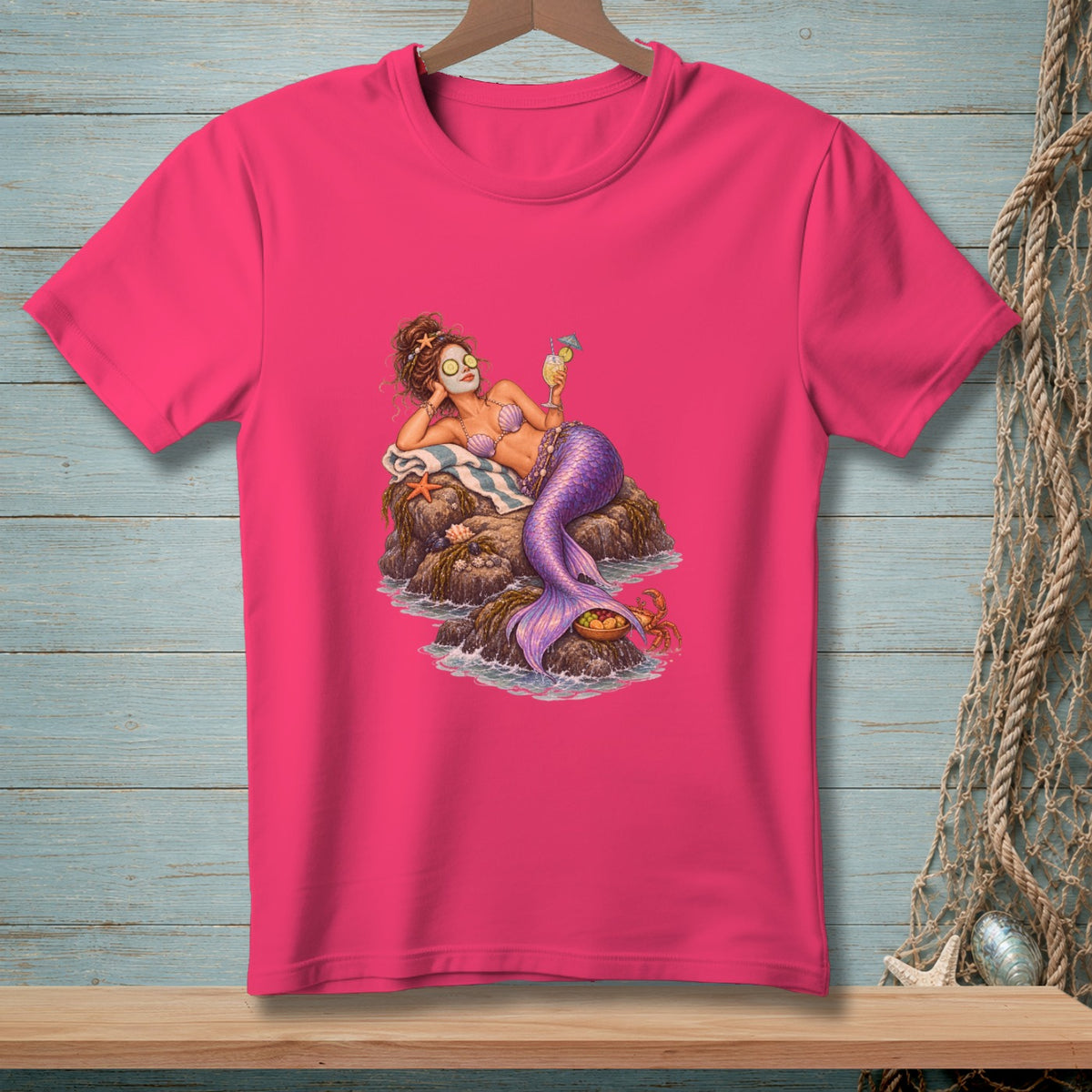 Mermaid with facial mask and drink lounging on rocks with a crab.