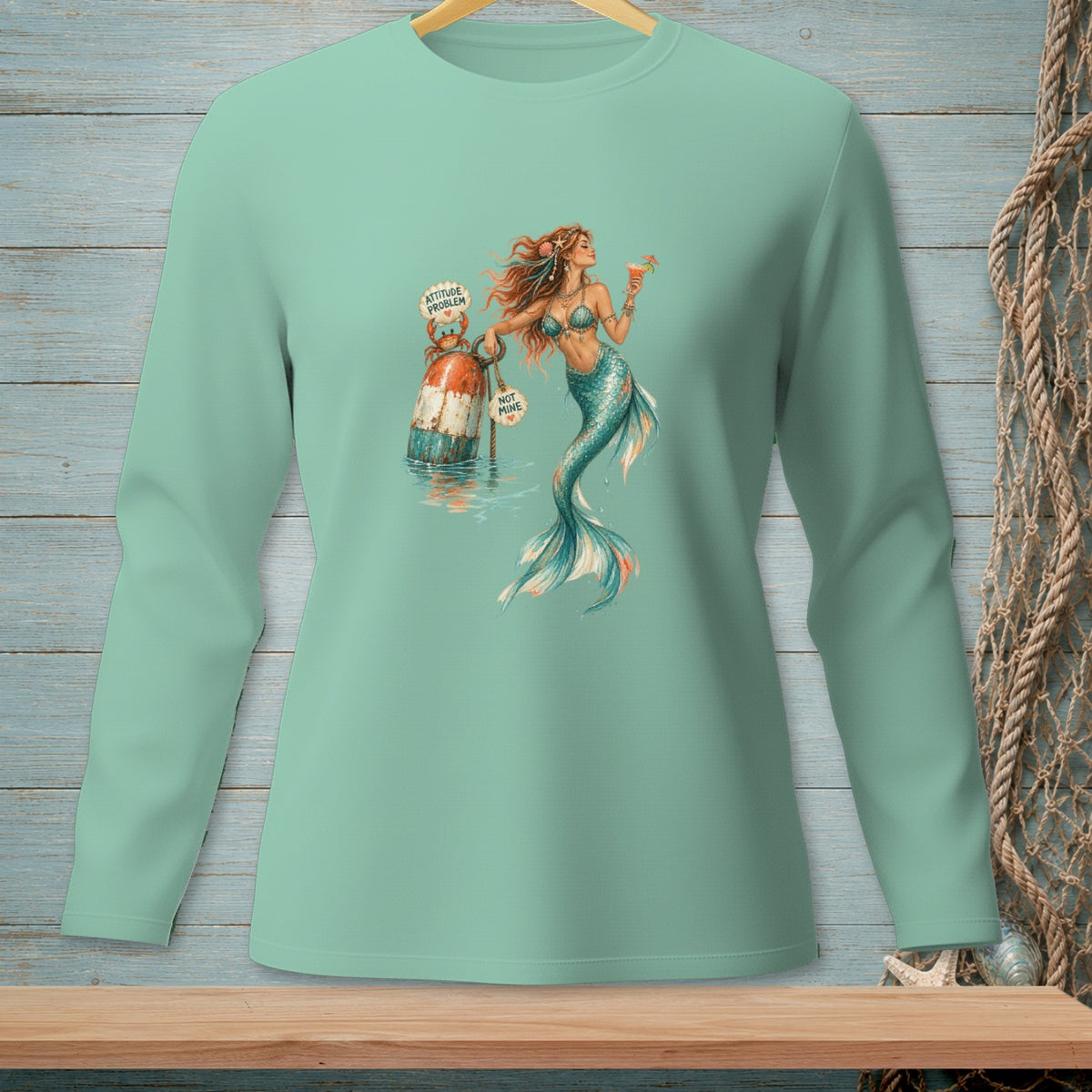 Mint long sleeve shirt with a mermaid holding a drink and a buoy.