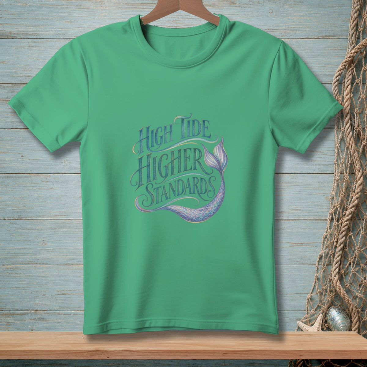 Green t-shirt with "High Tide Higher Standards" text and mermaid tail graphic.