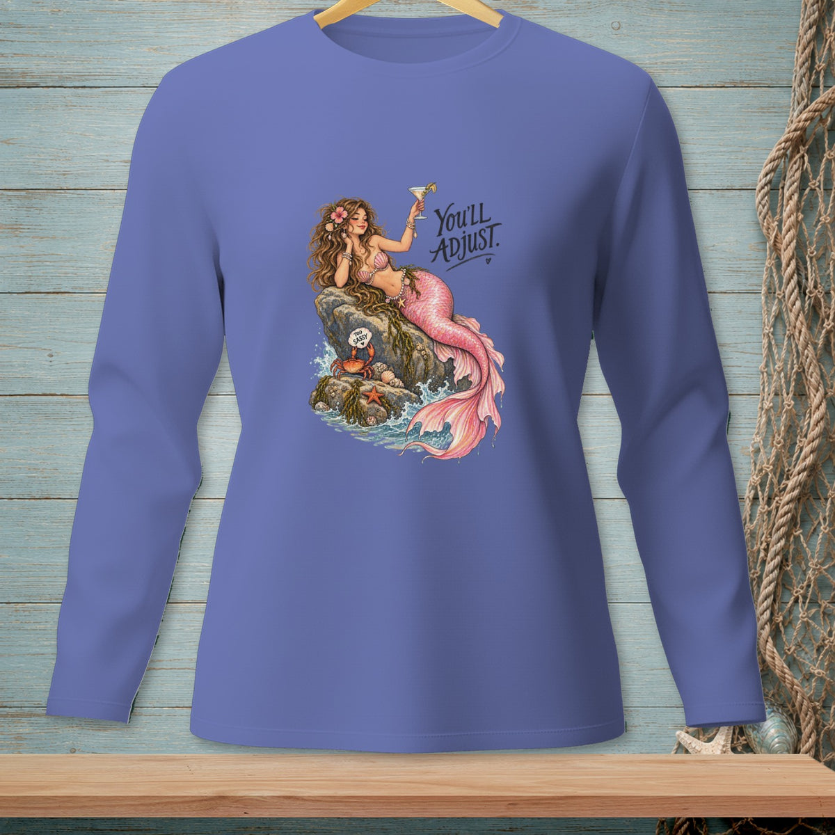 Mermaid with pink tail sits on rock holding cocktail, text says "You'll ADJUST."