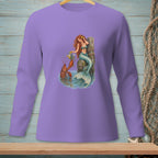 Mermaid with flowers and lobster by a wooden post in water graphic on a purple long-sleeve shirt.