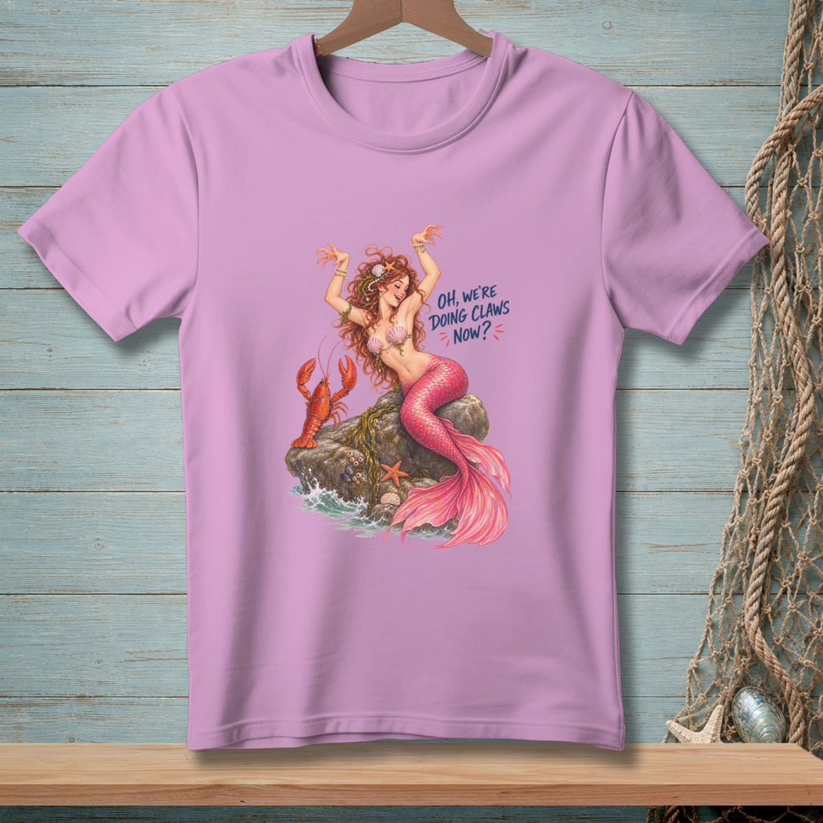 Pink t-shirt with mermaid, lobster, and text "Oh, we're doing claws now?".