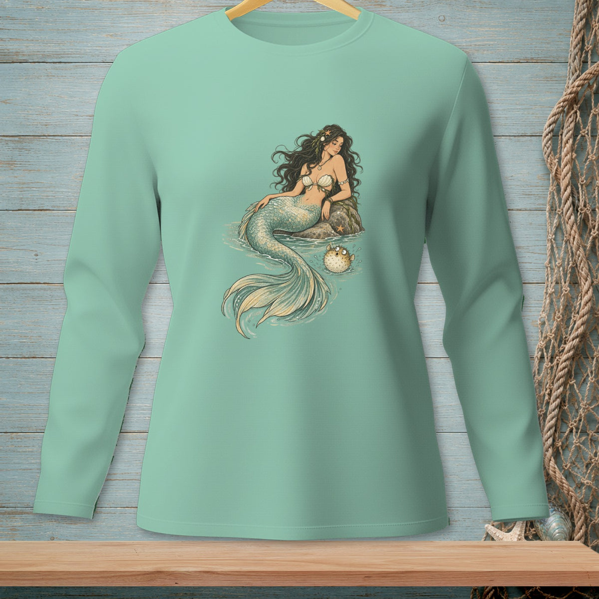 Long sleeve shirt with a vintage mermaid and pufferfish illustration.