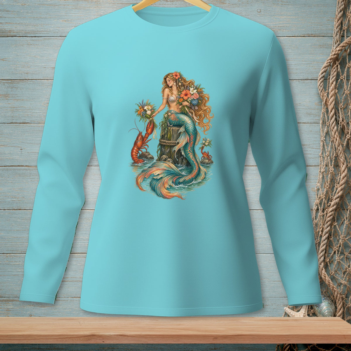 Turquoise long-sleeved shirt featuring a mermaid holding flowers with a lobster and crab.