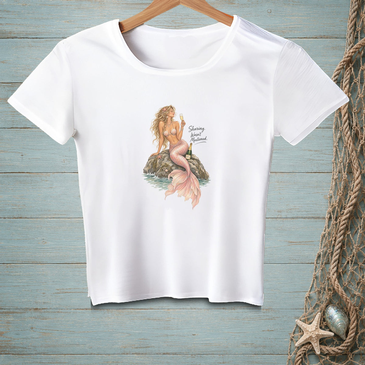 White t-shirt with a mermaid illustration and the text "Sharing Wasn't Mentioned."