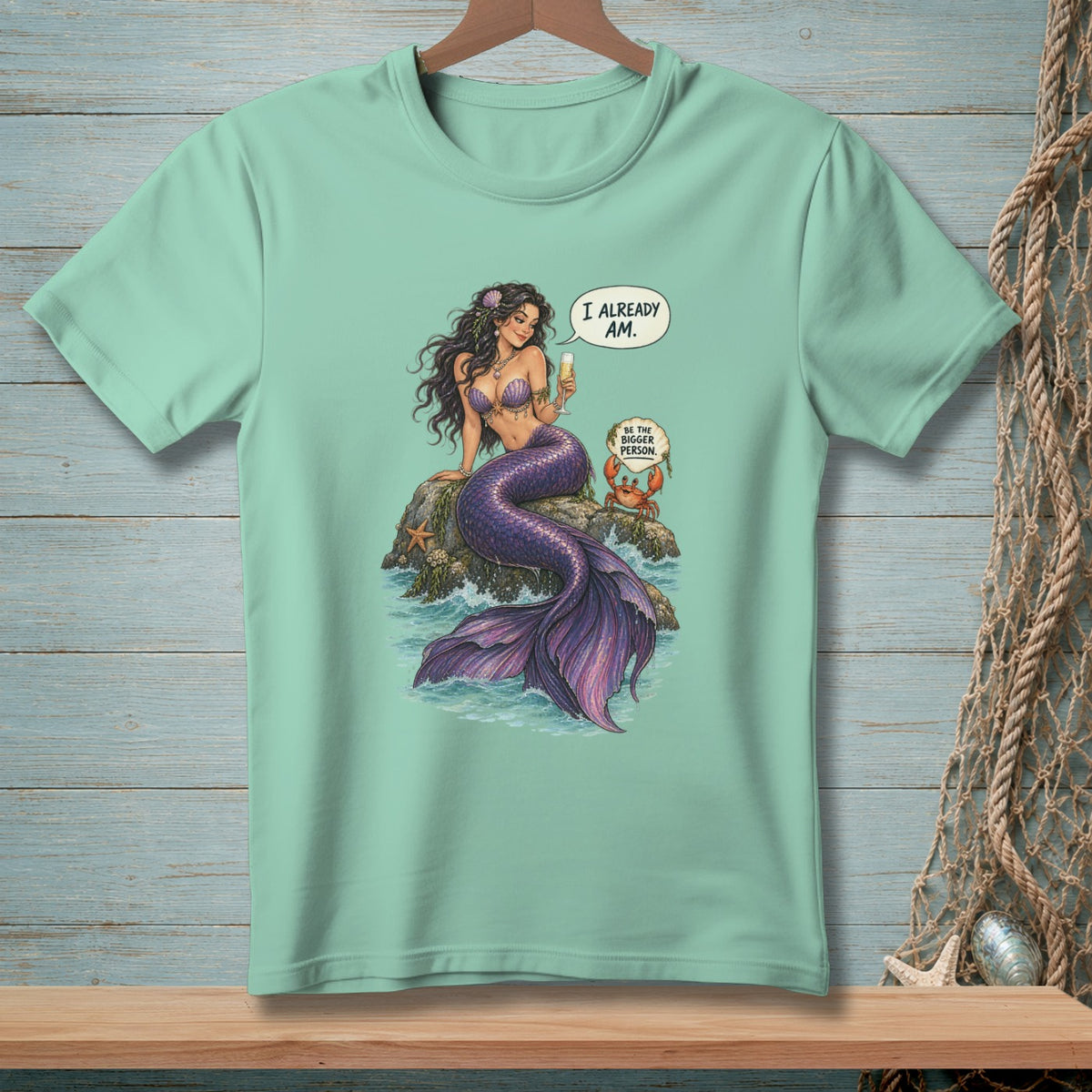 Mermaid with a drink saying "I already am," with a crab saying "Be the bigger person."