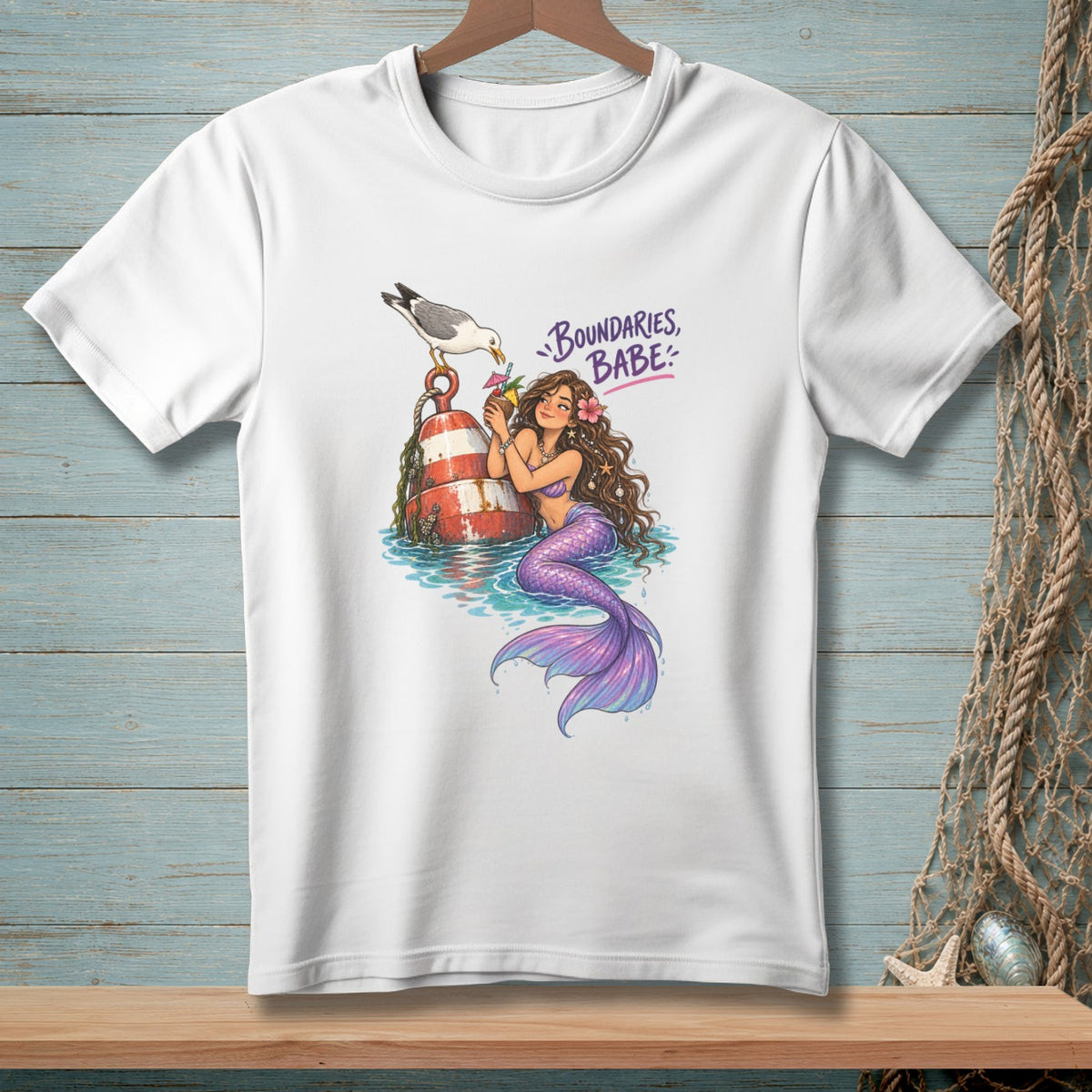 White t-shirt graphic with mermaid, seagull, buoy, and "Boundaries, Babe" text.