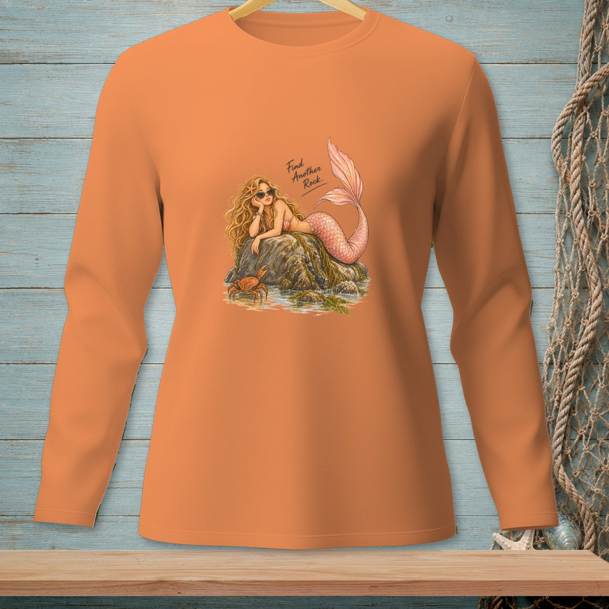 Orange long-sleeve shirt with a mermaid illustration and the text "Find Another Rock".