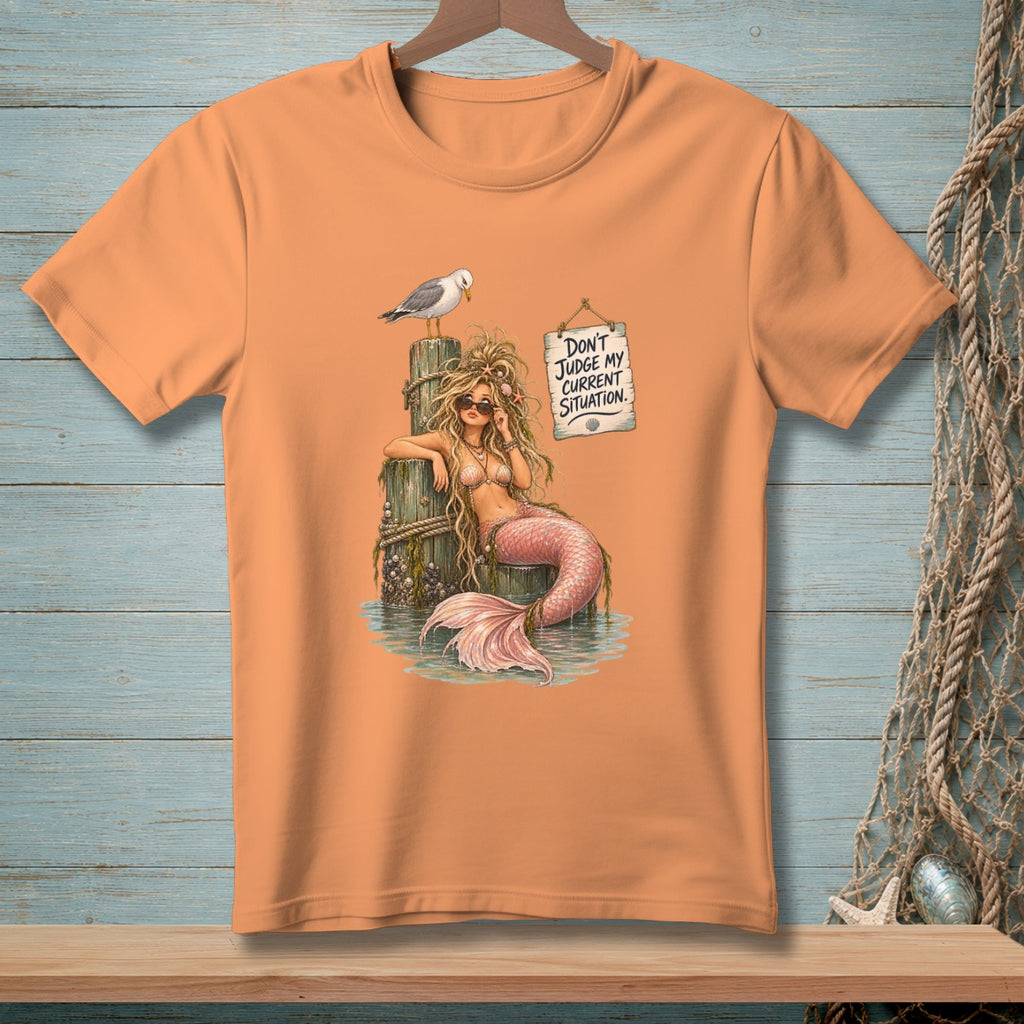 Peach t-shirt with mermaid graphic and text "Don't Judge My Current Situation."
