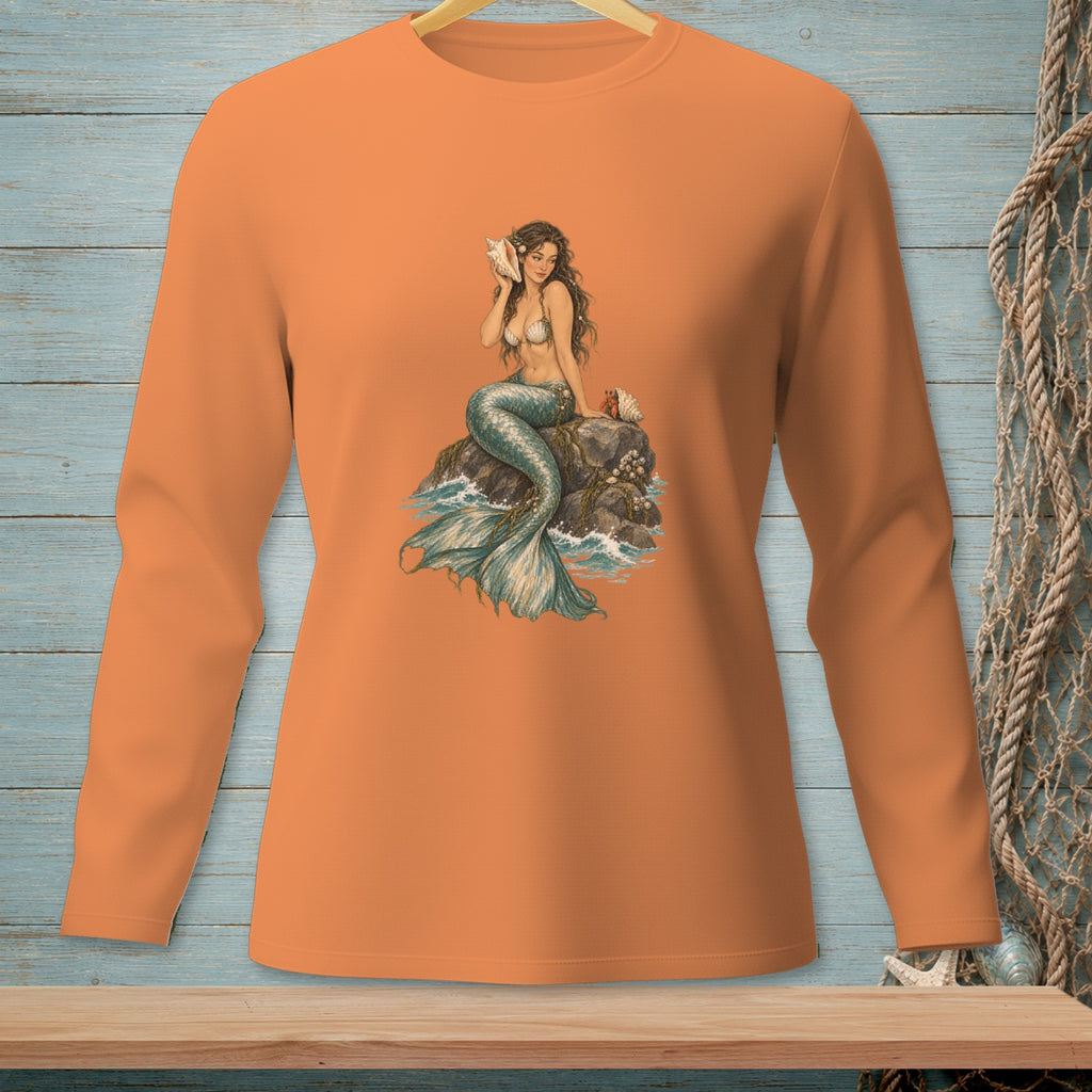Orange long-sleeve shirt with a mermaid sitting on a rock by the sea.