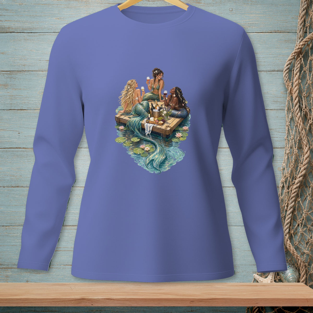 Three mermaids with wine glasses sit on a raft surrounded by water lilies.