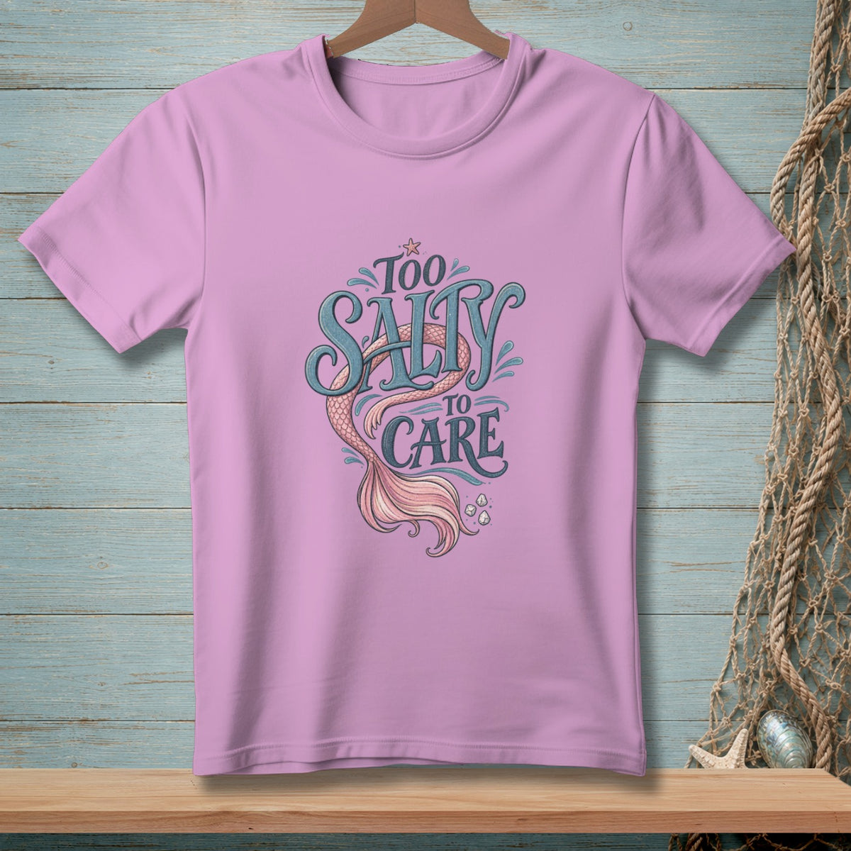 Pink t-shirt with "Too Salty To Care" text and mermaid tail design.