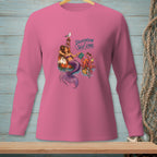 Pink long-sleeve shirt with a mermaid and octopus graphic, text reads "Delegation is Self-Care".