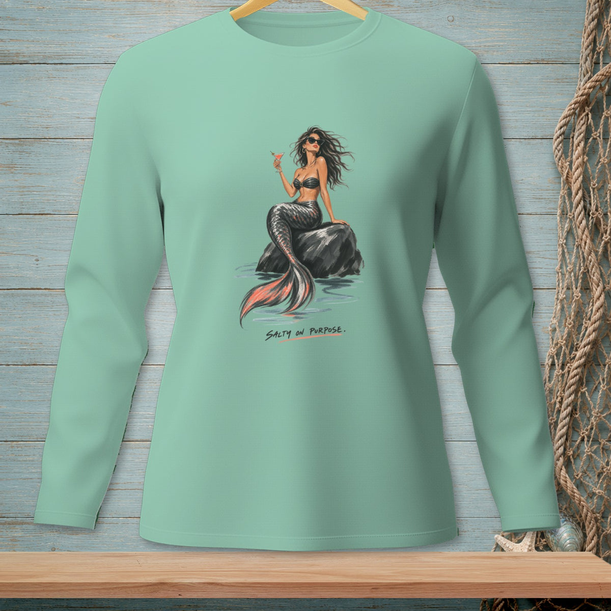 Mint green long-sleeve shirt with a mermaid holding a drink, text "Salty On Purpose."