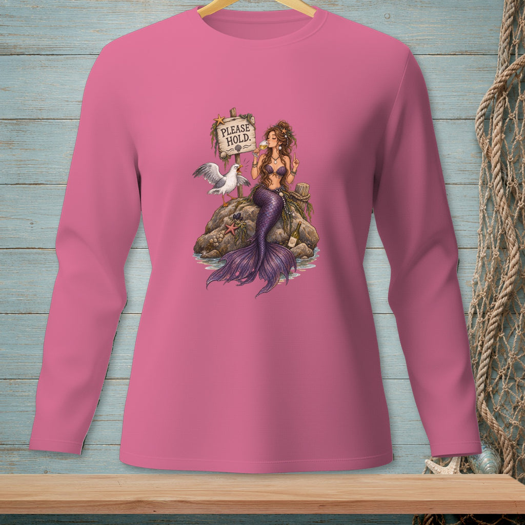 Pink long-sleeve shirt featuring a mermaid and seagull on rocks with a "PLEASE HOLD." sign.