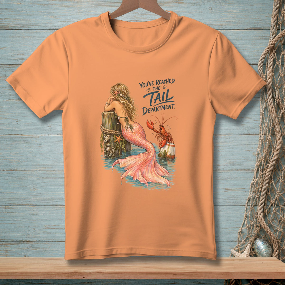 Orange t-shirt with mermaid and lobster graphic and "You've Reached the Tail Department" text.