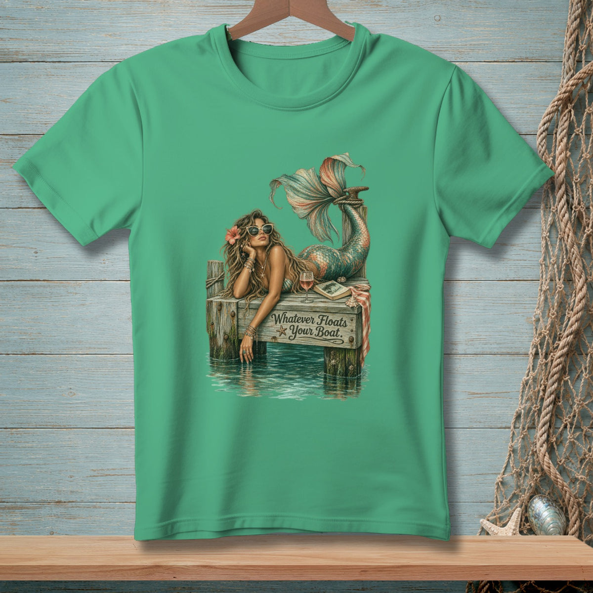 Mermaid on dock with sunglasses, text "Whatever Floats Your Boat."
