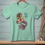 Light mint t-shirt with a mermaid illustration and text that reads "Hair's a wreck. Priorities intact."