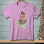 Purple t-shirt with a watercolor illustration of a mermaid sitting on a rock.